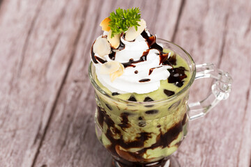 Green tea ice cream in glass cup.Collection of different desserts.Gourmet summer dessert of artisanal or craft ice cream made.Cafe menu.