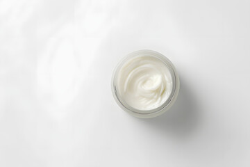 Elegant image of an open jar filled with rich, creamy moisturizer. Positioned against a clean, white backdrop, this minimalistic composition highlights the product's purity and quality mockup