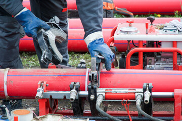 Carrying out butt welding of polyethylene pipes in the field.