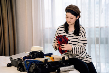 Young Woman Organizing Suitcase for a Trip