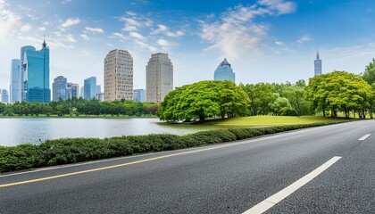 View of road highway with lake garden and modern city skyline in background.