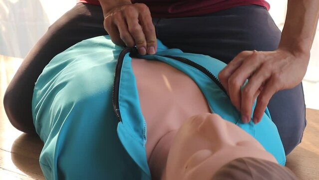 Close-up of CPR on doll's hand (Cardiopulmonary Resuscitation) A resuscitation technique used in emergencies to resuscitate a person who has stopped breathing or whose heart has stopped beating.