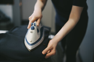 Perfecting the Look: Person Ironing Clothes Smoothly