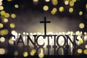 word sanctions spelled in letters on table made of wooden block letters with dramatic lighting and...