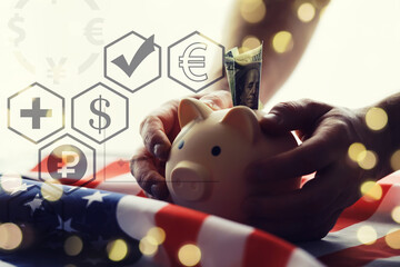 Piggy bank on USA flag close-up. Saving money in United States concept.