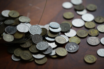 Russian rubles and metal coins inside a glass jar close-up on black blurred background