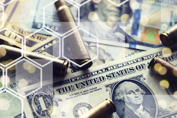 Live ammunition with bullets,  bills, close-up, selective focusing. Concept: sale of weapons under...