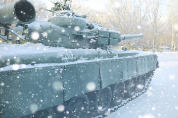 Military tank in a row. Battle tank in the snow on the roadside of highway. War in Ukraine in...