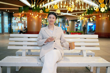 Stylish Businesswoman Enjoying Coffee Break at Mall