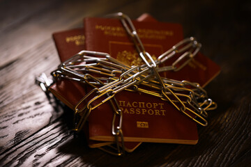 Russia Sanctions and banned russian people, Russian Federation passports with padlock and chain....