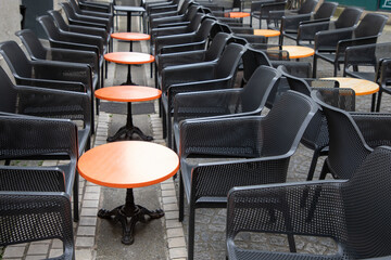 vintage Parisian style empty coffee terrace with trendy french paris design tables and black chairs