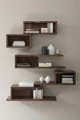 A series of modern wall-mounted shelves with clean lines and minimalist design, arranged in a staggered formation on a plain wall, offering stylish storage solutions for books, decor, and more. 