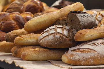 Different kinds of fresh bread on the bakery counter