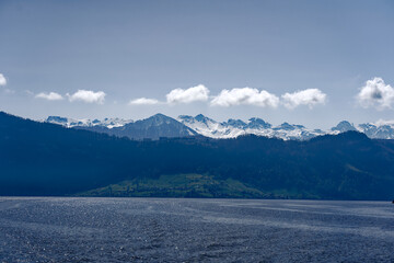 Rural landscape in the Swiss Alps seen from passenger ship running on Lake Lucerne between...