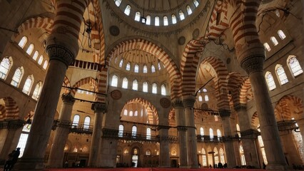 Obraz premium Solemn and serene mosque interior bathed in sunlight