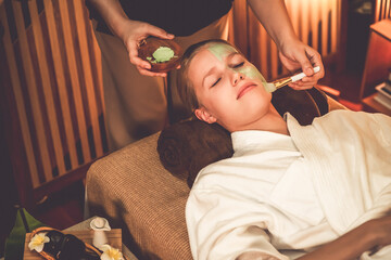 Serene ambiance of spa salon, woman customer indulges in rejuvenating with luxurious face cream...