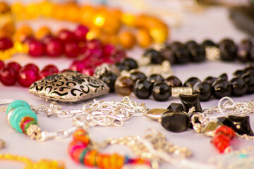 Abstract Art Accessory shooting, gem Nacklace and bracelet with silver, gem colored stone, white texture background, artistic style, photo is selective focus with shallow depth of field. Cairo Egypt
