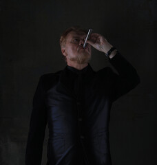 portrait of an old red-haired man in a black jacket