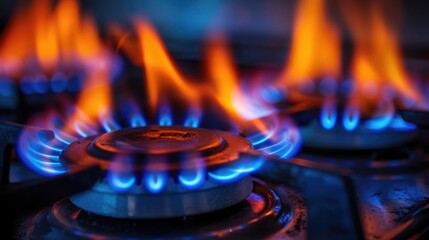 closeups of a natural gas stove flame on dark background