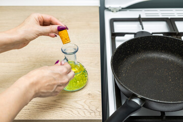  housewife opens a bottle of cooking oil.