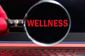 Wellness sign text appeared through a magnifying glass on a black background