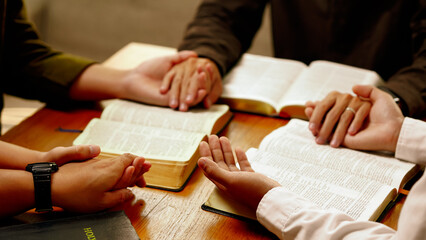 Christian friend's groups read and study the bible together in a home with window light. followers...