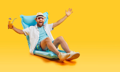 Happy man relax on an inflatable mattress isolated on orange backdrop. Savoring the summer...