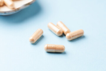 Coenzyme Q10 capsules. Dietary supplements. Bright paper background. Close up.	