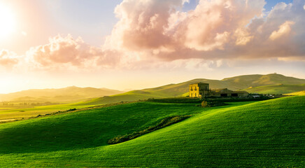 sceniv view at a nice farm in green fields in hills and highlands, landscape of spring green hills...
