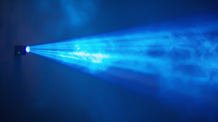 A blue light is shining on a wall