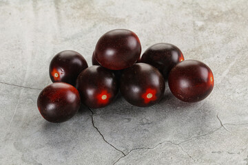 Raw ripe black kumato tomato