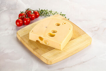 Maasdam cheese brick over board