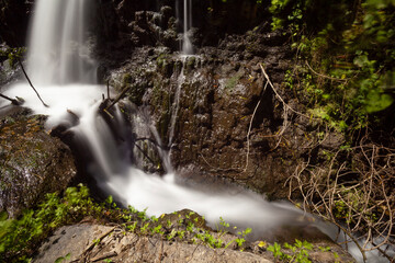 Fototapeta premium Nature's Elegance: Long Exposure Waterfall Photography Along Rio Fratta, Corchiano
