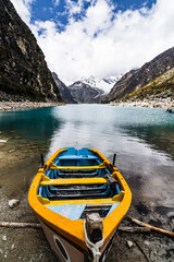 panormaic view of a boat on laguna paron in the snow-covered andes in the Huascarán national park...