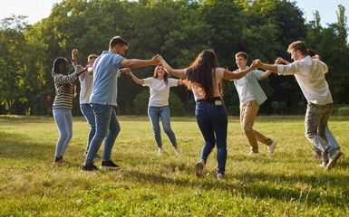 Group of happy diverse friends enjoying summer and having fun in beautiful sunny park. Eight...