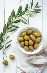 Bowl of Green Olives on a Rustic White Wooden Table With Olive Branches