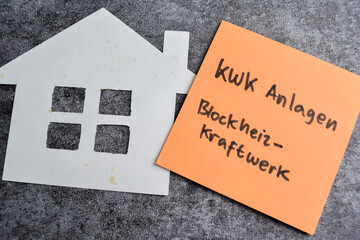 Concept of Kwk Anlagen Blockheizkraftwerk write on sticky notes isolated on Wooden Table.