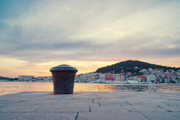 Iron bollard for mooring of ships at pier. Landscape with sea wharf. Split, Croatia.