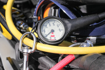 Diving equipment background. Manometer with pressure indicator. Dive hobby. Yellow diving air hose....