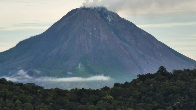 Mountains with tropical forest and Mount Sinabung. Sumatra, Indonesia.