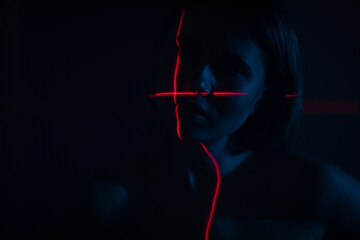 Shine a red laser in the shape of a cross at the girl. Future and virtual reality concept