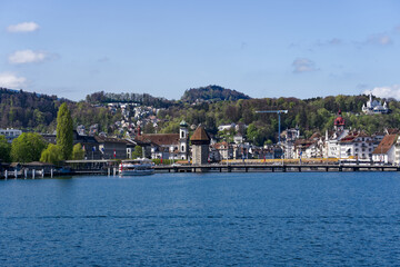 Fototapeta na wymiar Scenic view of Swiss City of Lucerne seen from passenger ship on Lake Lucerne on a sunny spring noon. Photo taken April 11th, 2024, Lucerne, Switzerland.