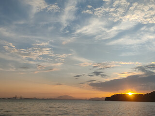 Fototapeta premium A picture of the sun setting in the evening sky. Background picture concept about the environment.