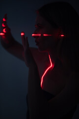 Shine a red laser in the shape of a cross at the girl. Future and virtual reality concept