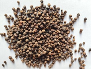 Black pepper on white background 