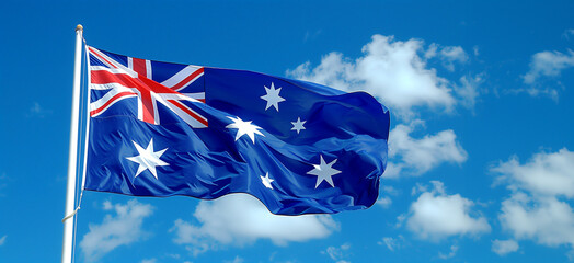 a beautiful Australian flag on a flagpole flying against the background of a blue sky with white clouds symbolizes a bright future and the independence of the state