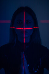 Shine a red laser in the shape of a cross at the girl. Future and virtual reality concept