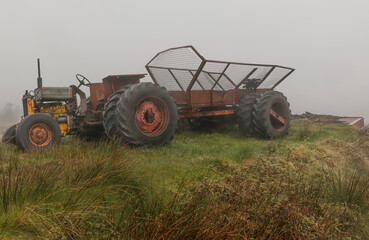Old tractor  and trailer in the bogs of County Galway in the mist