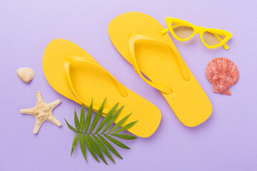 Bright yellow flip-flops on color background, top view. Summer concept