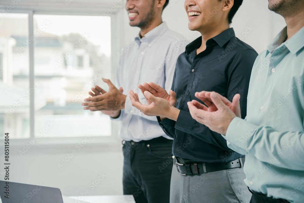 Poster three men are standing in a room, clapping their hands and smiling